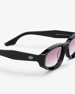 Black sunglasses with pink lenses on a white background