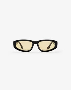 Black-framed sunglasses with yellow-tinted lenses on a white background