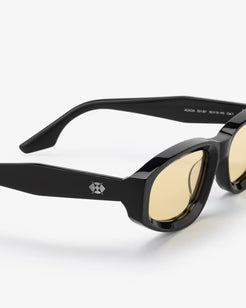 Black sunglasses with gold lenses on a white background