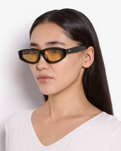 Woman wearing sunglasses with a plain background