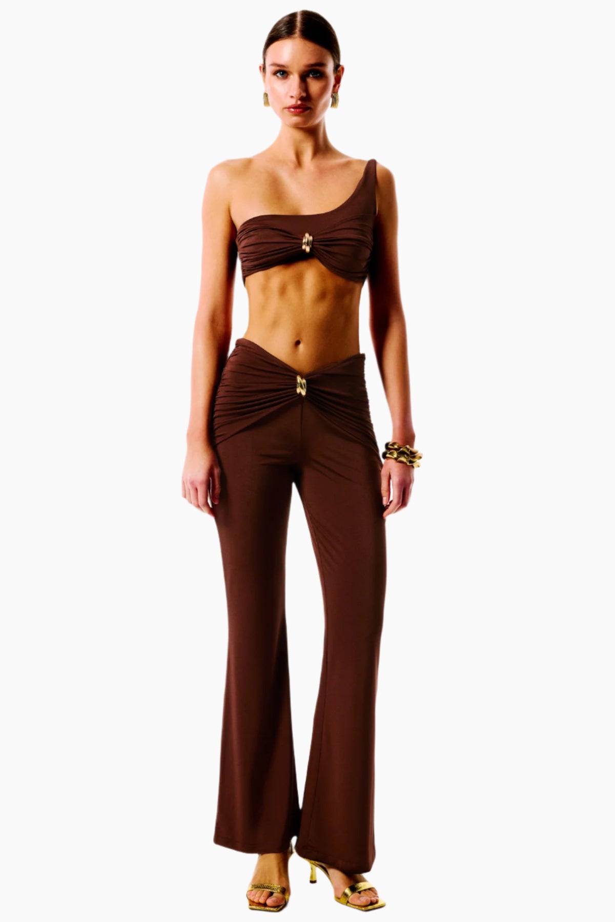Woman wearing a brown one-shoulder top and wide-leg pants