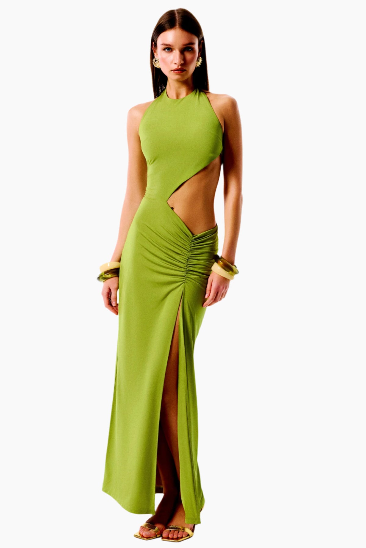Woman wearing a green evening gown with cut-out design