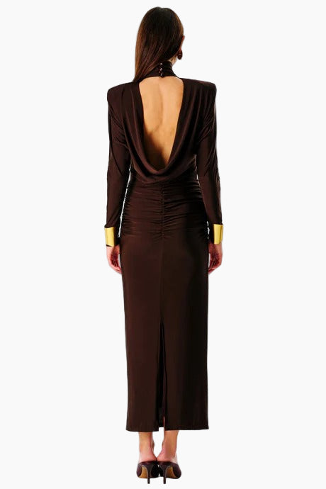A model wearing a brown backless maxi dress with three-quarter sleeves and a V-neck neckline.