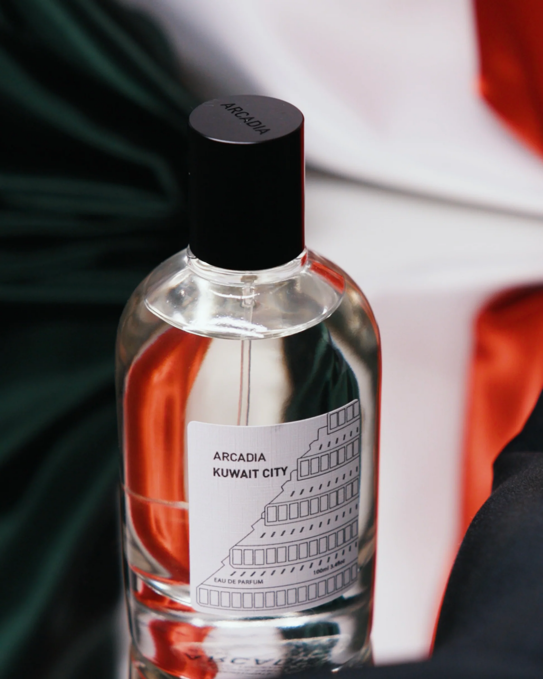 Perfume bottle with a small image of smoke and leaves, sandalwood, patchouli, cedarwood, musk, oud accord