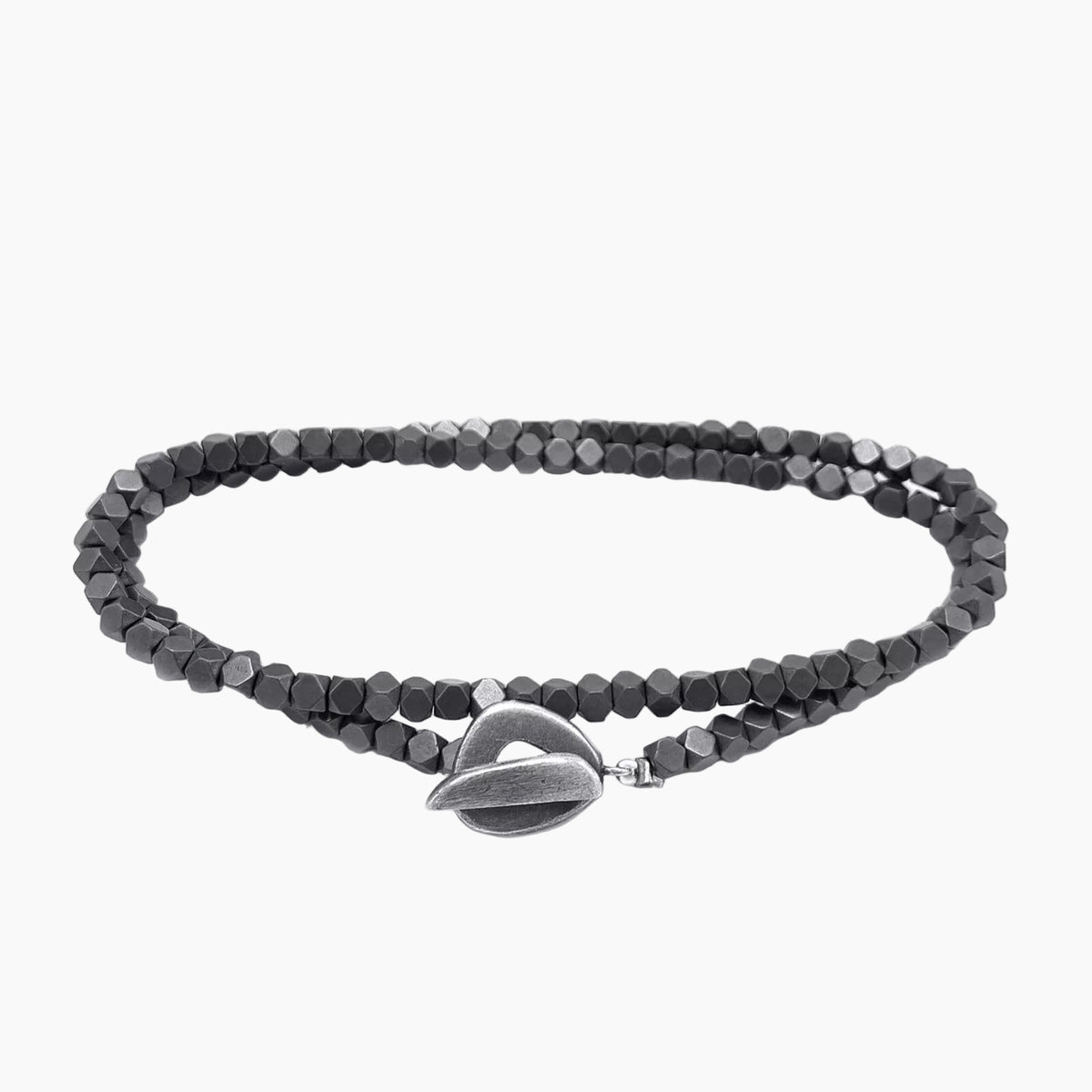 Black beaded bracelet with a silver heart-shaped clasp on a white background