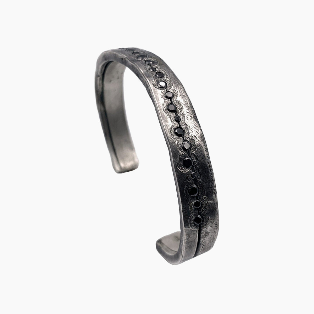 Silver bracelet with black stones on a white background