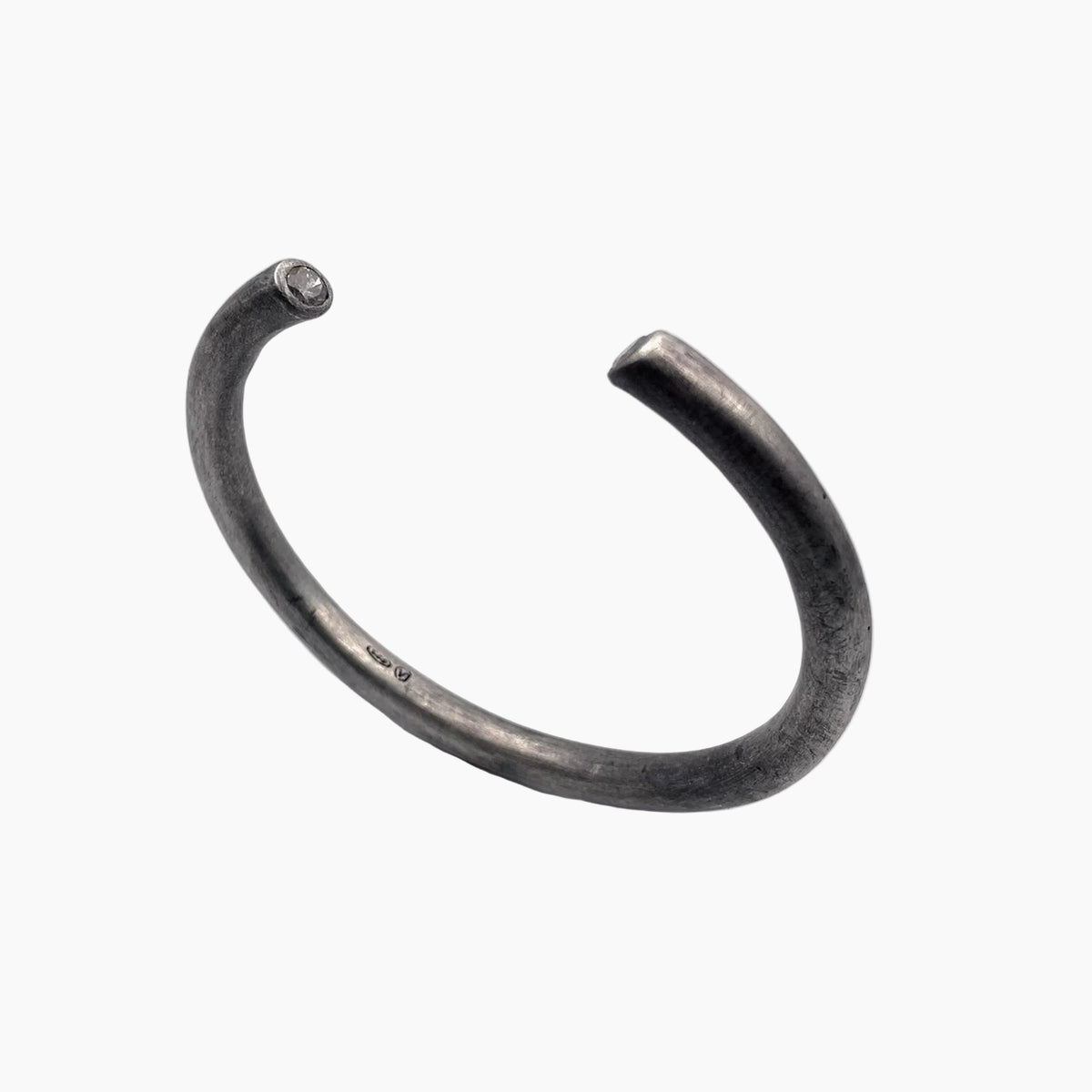 Silver bangle on a white background