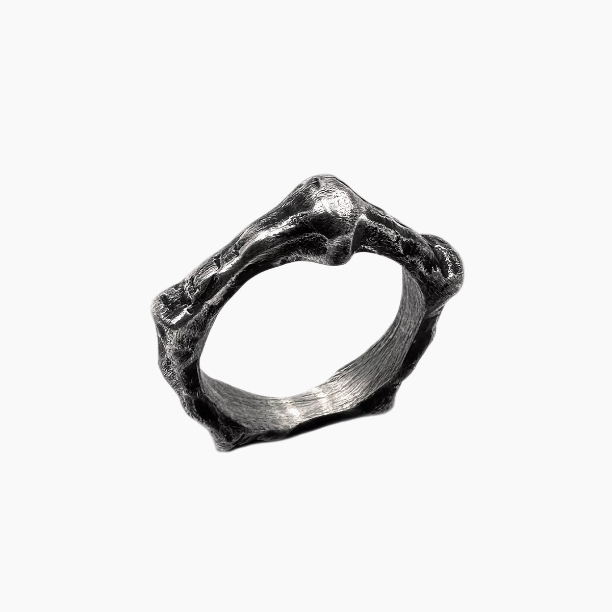 Silver ring with a textured design on a white background