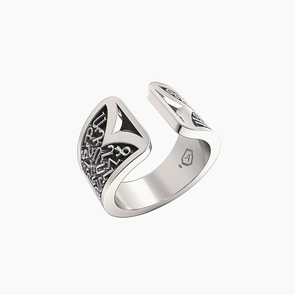 Silver ring with intricate designs on a white background