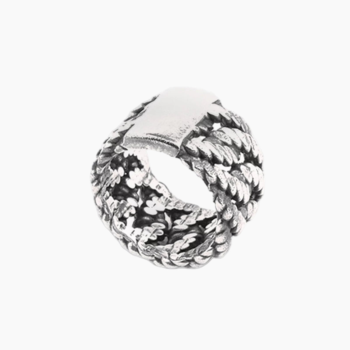 Silver ring with intricate design on a white background