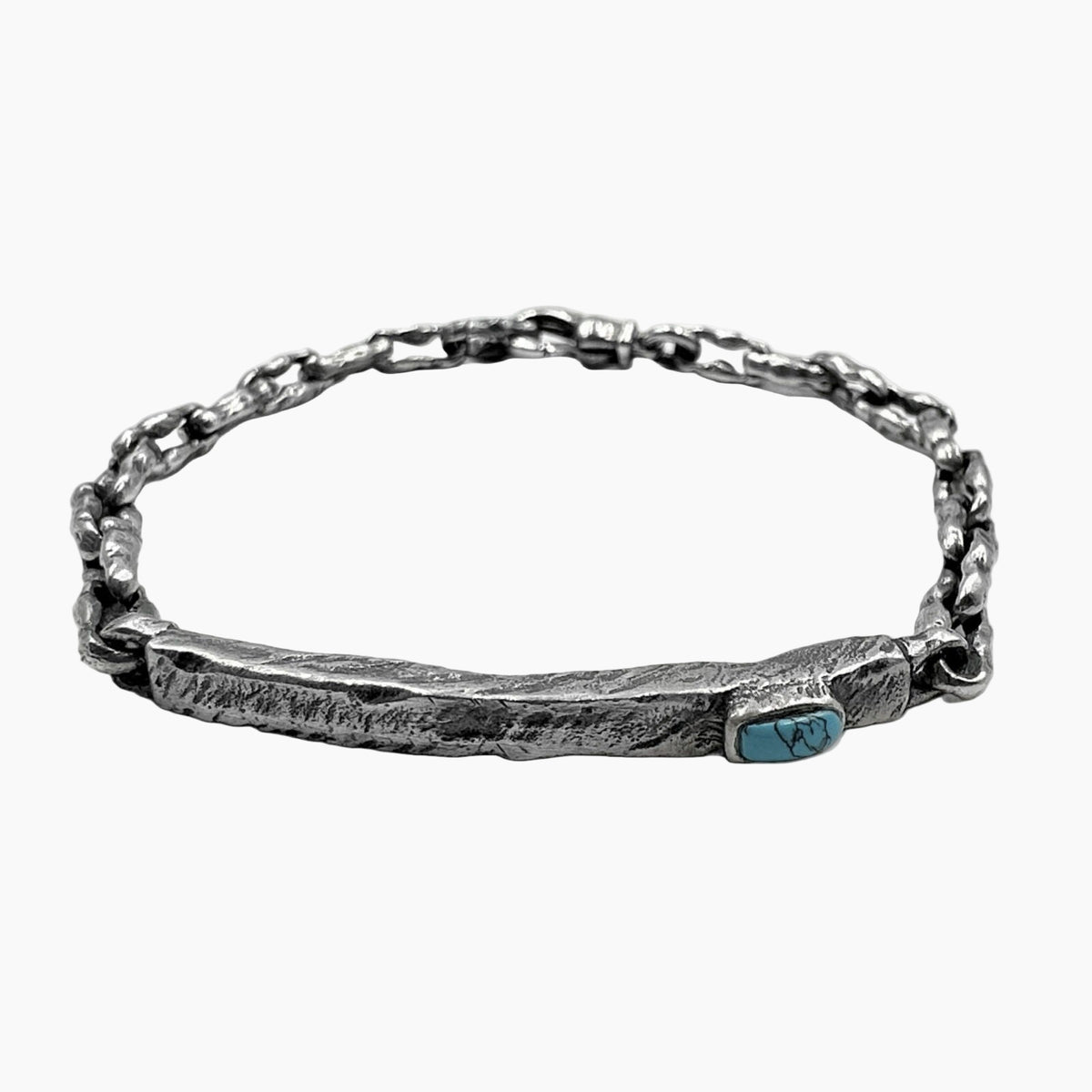 Silver bracelet with a turquoise stone on a white background
