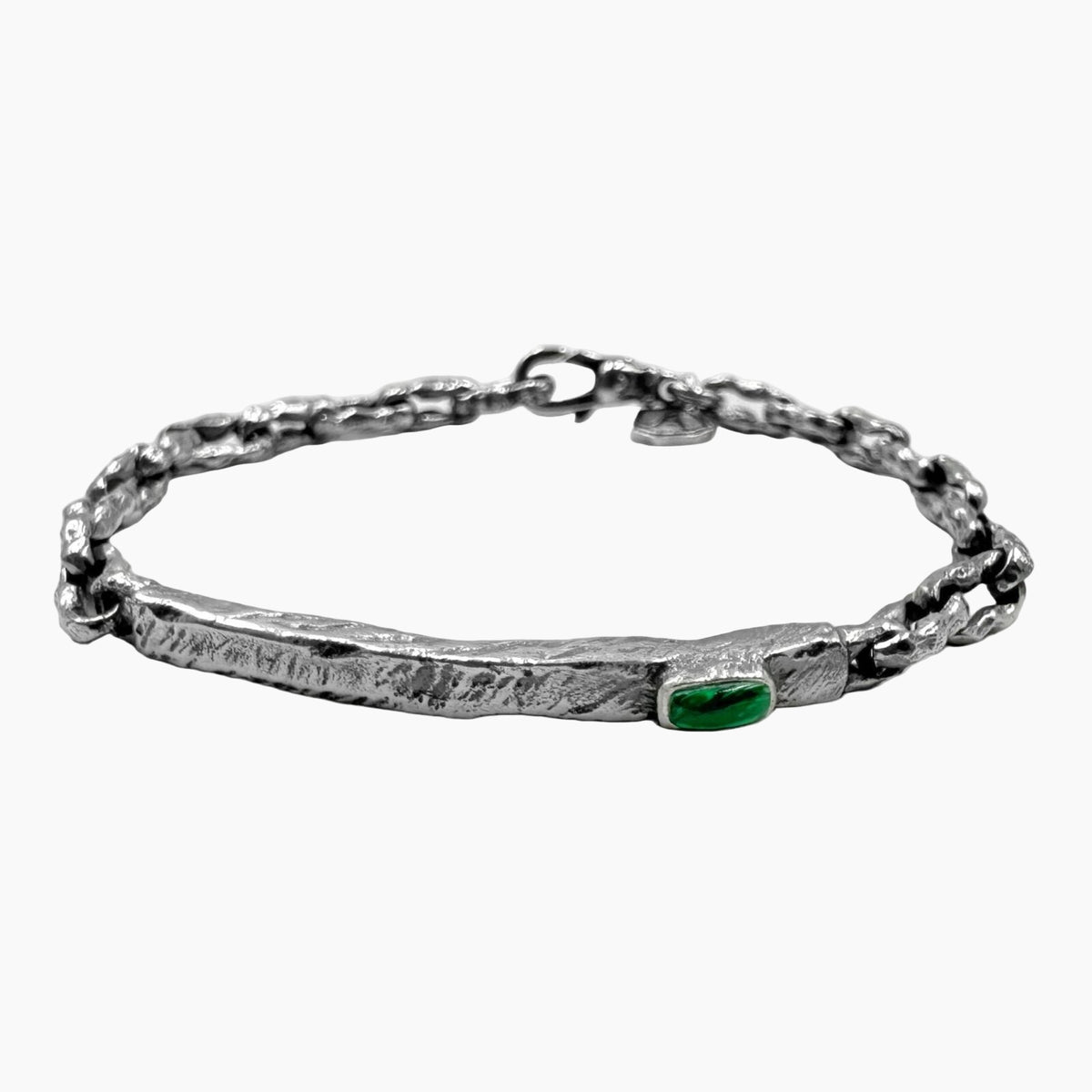 Silver bracelet with a green gemstone on a white background