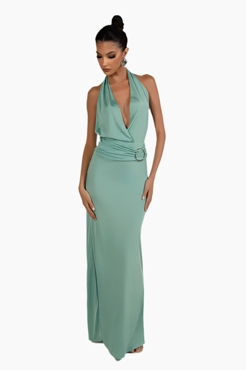 Woman wearing a green halter neck dress.