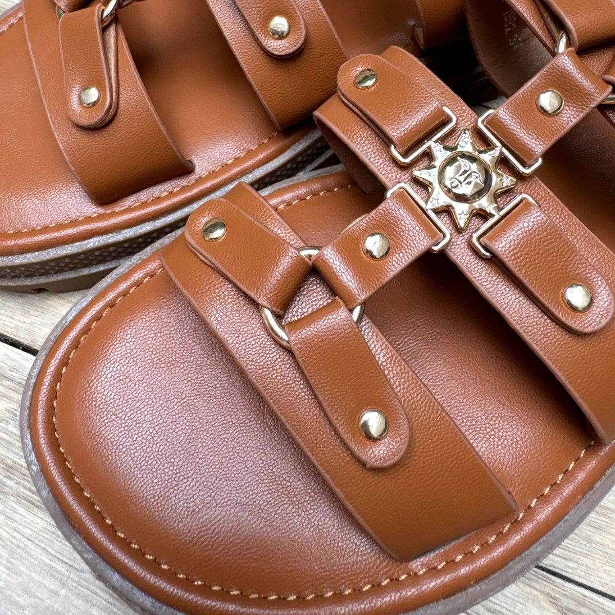 Brown leather sandals with gold buckles