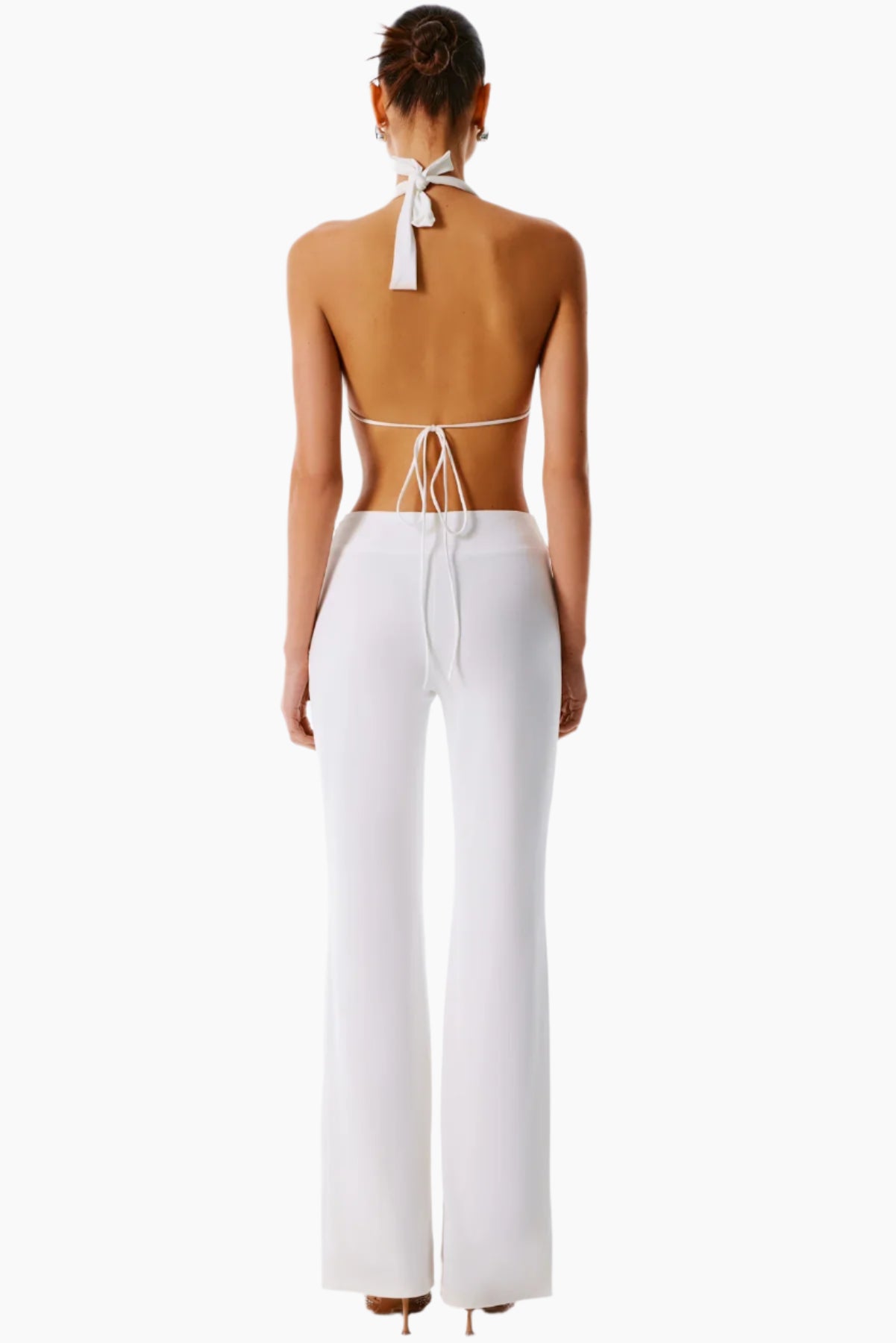 Woman wearing a white halter top and pants