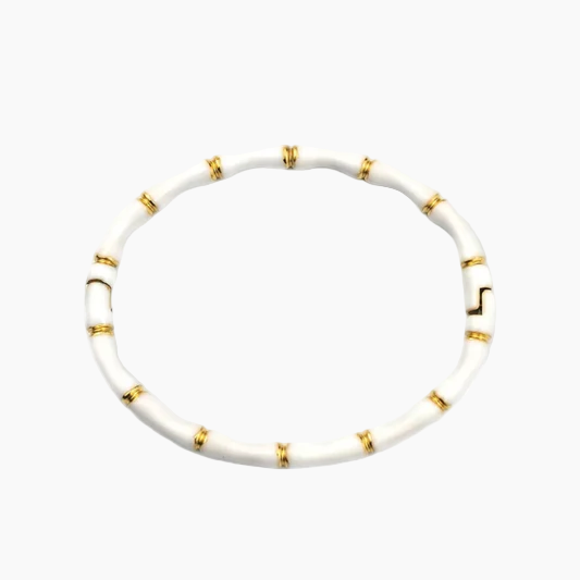 White necklace with gold accents on a white background