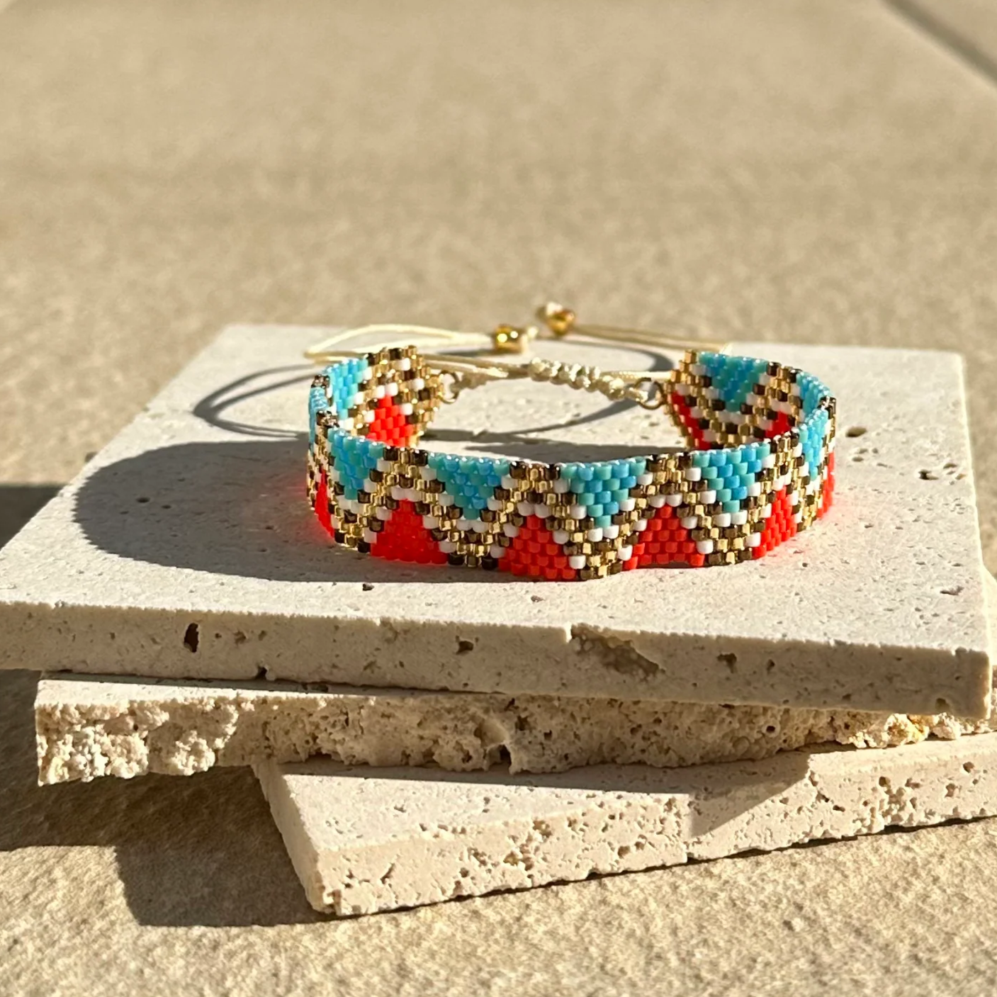 Colorful beaded bracelet on a stone surface