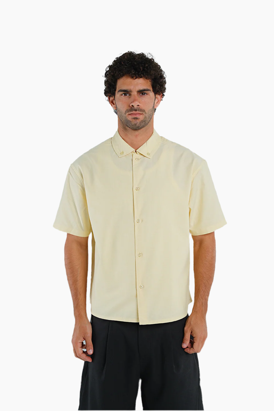 Man wearing a light yellow short-sleeve shirt