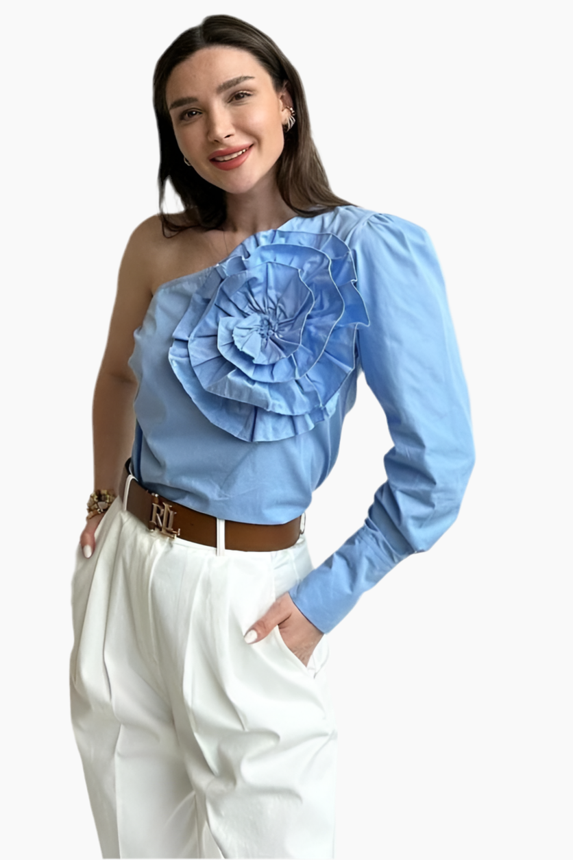 Woman wearing a blue one-shoulder top with a large floral design on a white background