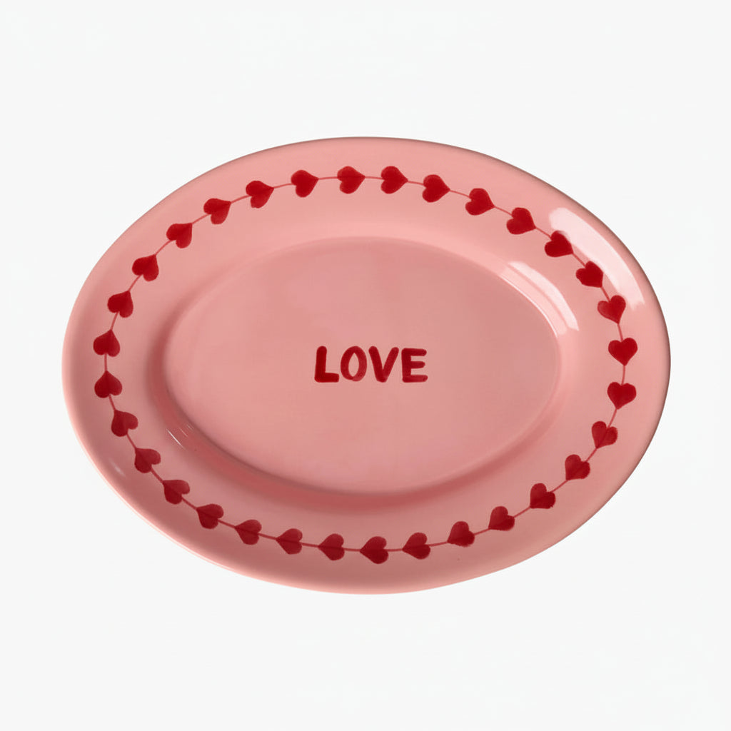 Pink plate with 'LOVE' text and heart designs