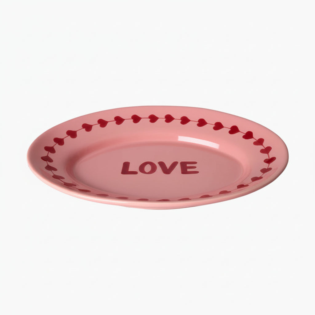 Pink ceramic plate with 'LOVE' text and heart patterns