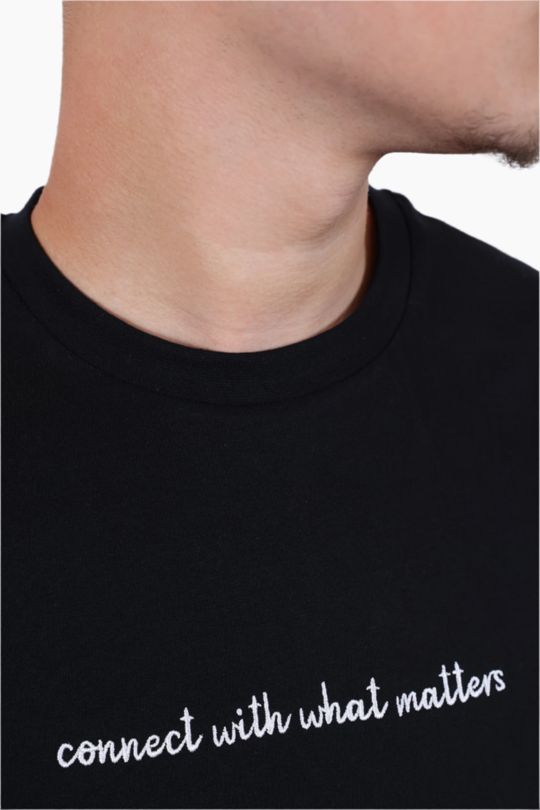 Person wearing a black t-shirt , "Connect with what Matters "T-Shirt ,Unisex