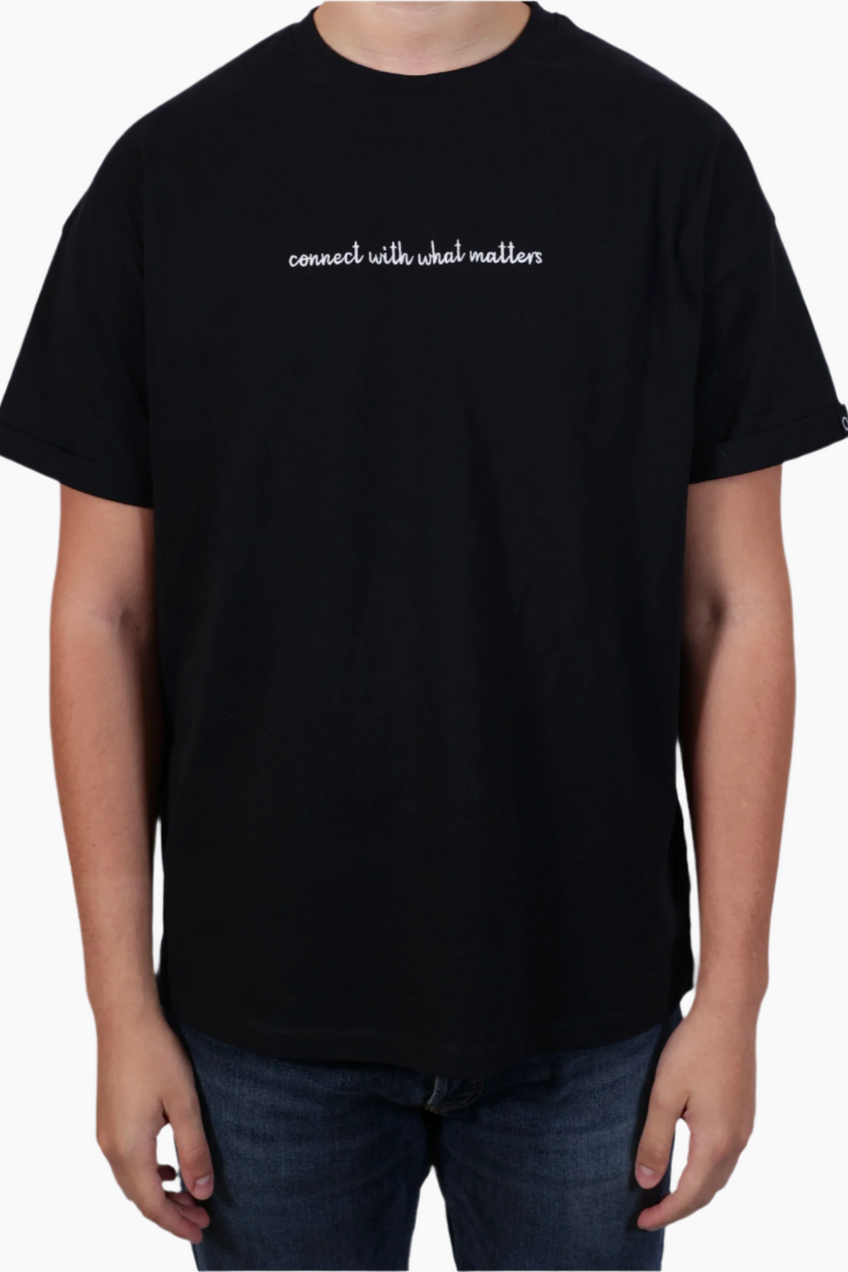 Person wearing a black t-shirt , "Connect with what Matters "T-Shirt ,Unisex