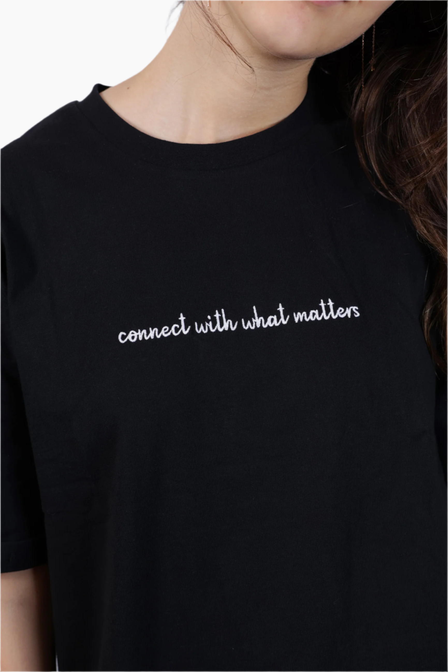 Person wearing a black t-shirt , "Connect with what Matters "T-Shirt ,Unisex