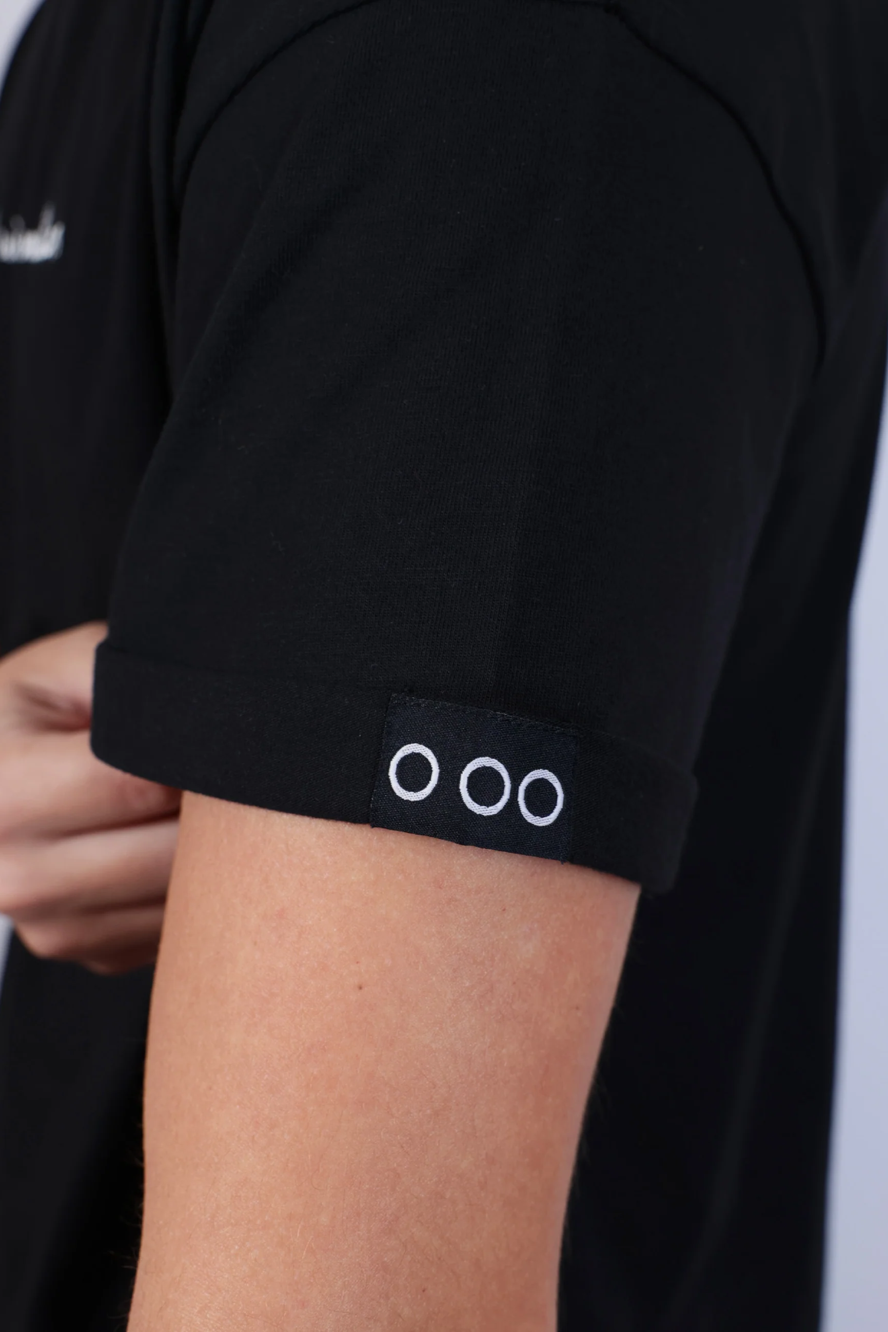 Black t-shirt with a logo on the sleeve