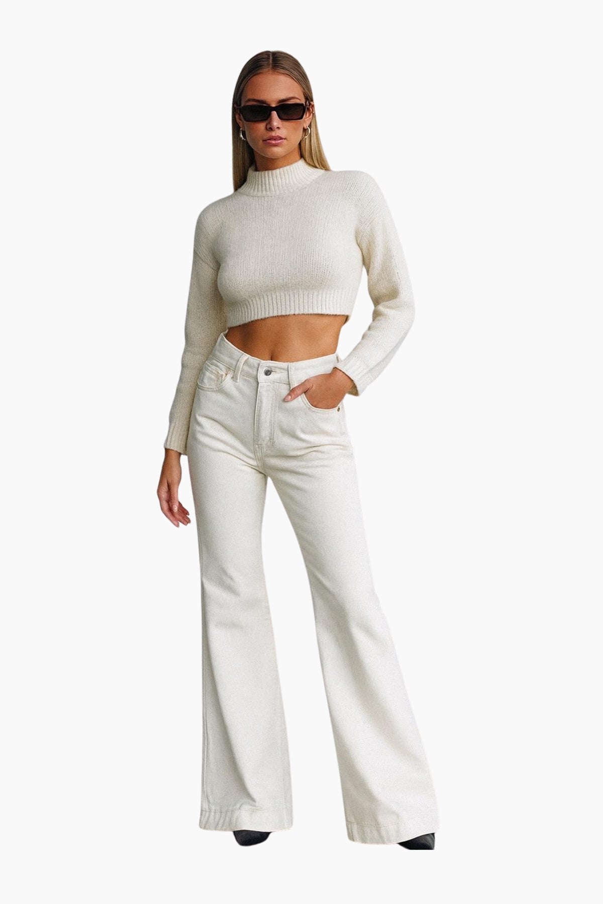 Woman wearing a white sweater and white pants on a white background