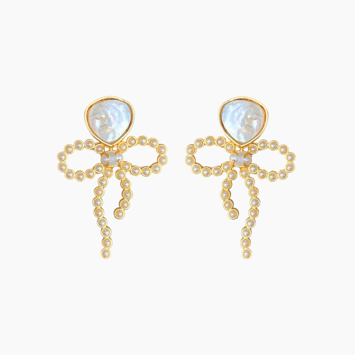 Pair of gold earrings with pearl-like stones on a white background
