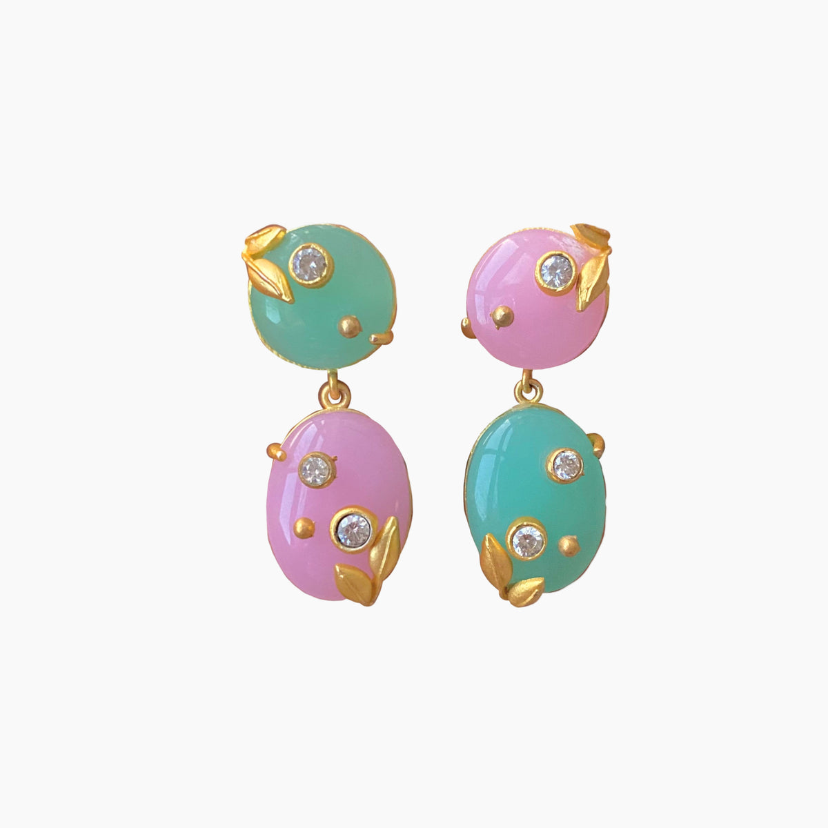 Pair of earrings with pastel green and pink stones on a white background