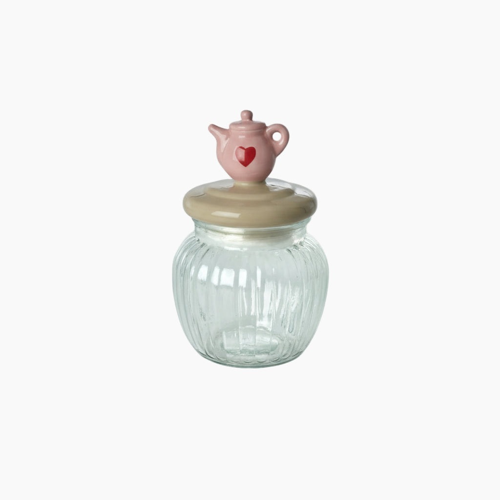Clear glass jar with a decorative pink lid featuring a heart design