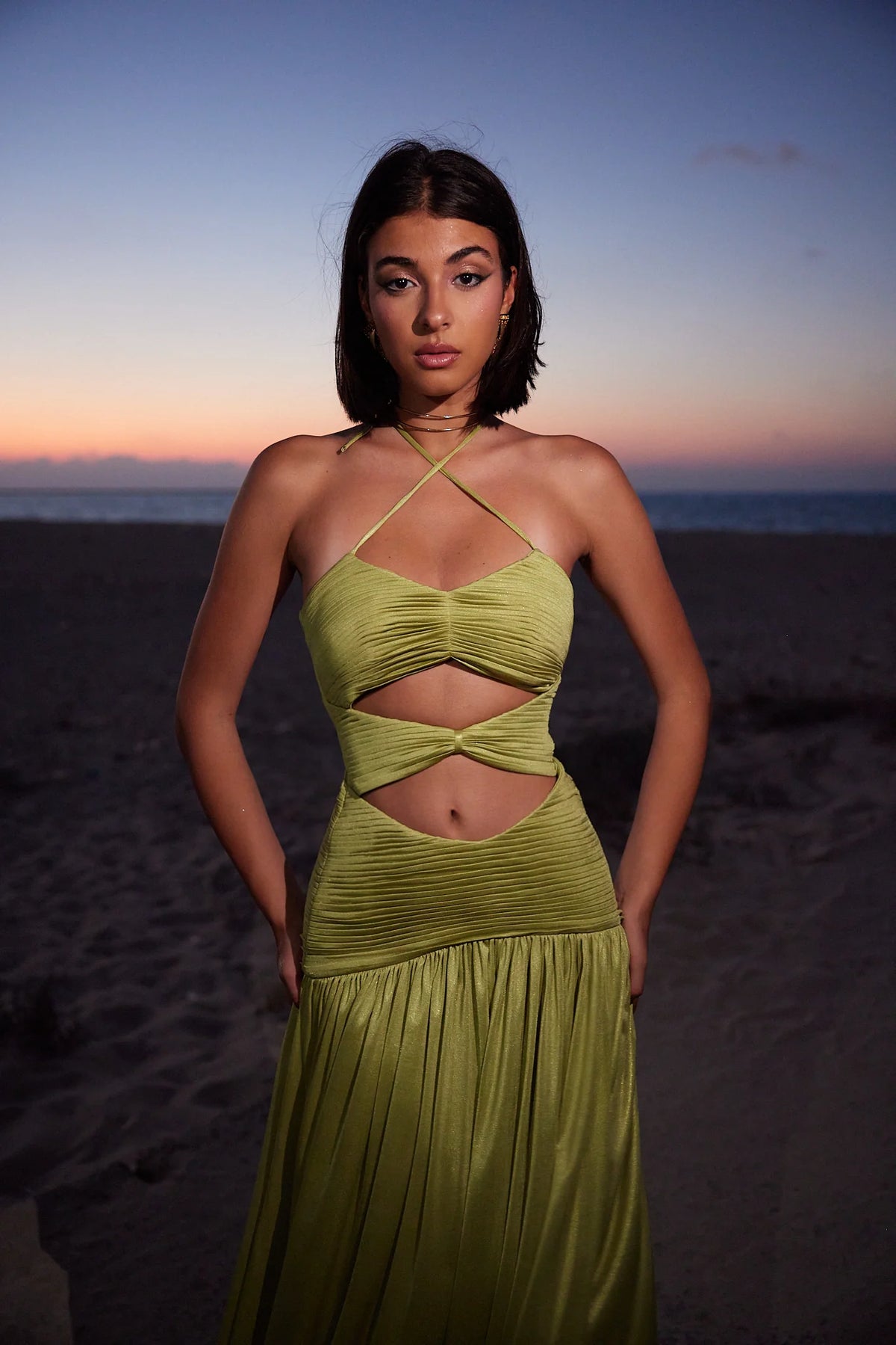 model wearing a green cut out dress