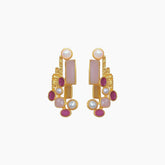 Gold earrings with pink and red stones on a white background