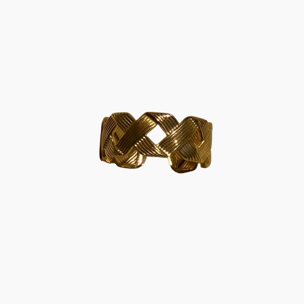 Gold woven ring on a white background