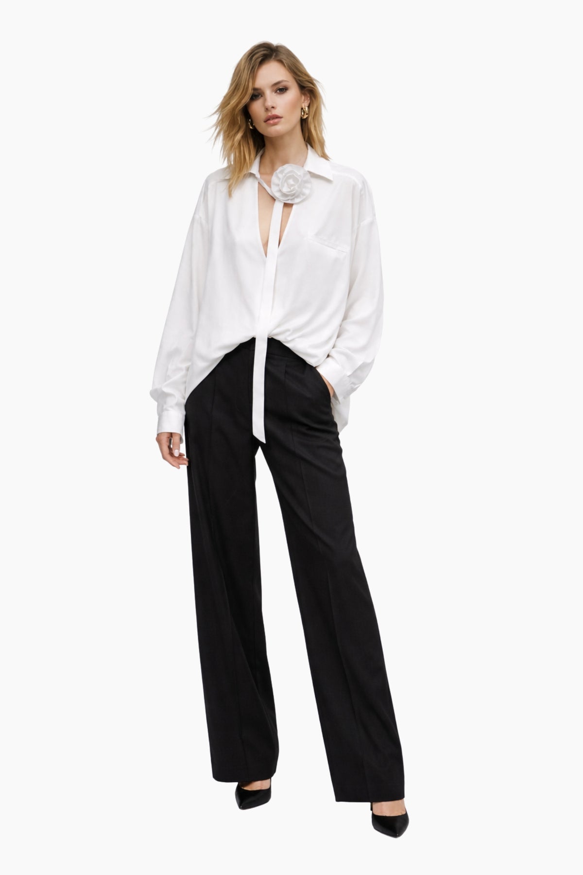 Woman wearing a white blouse and black pants on a white background