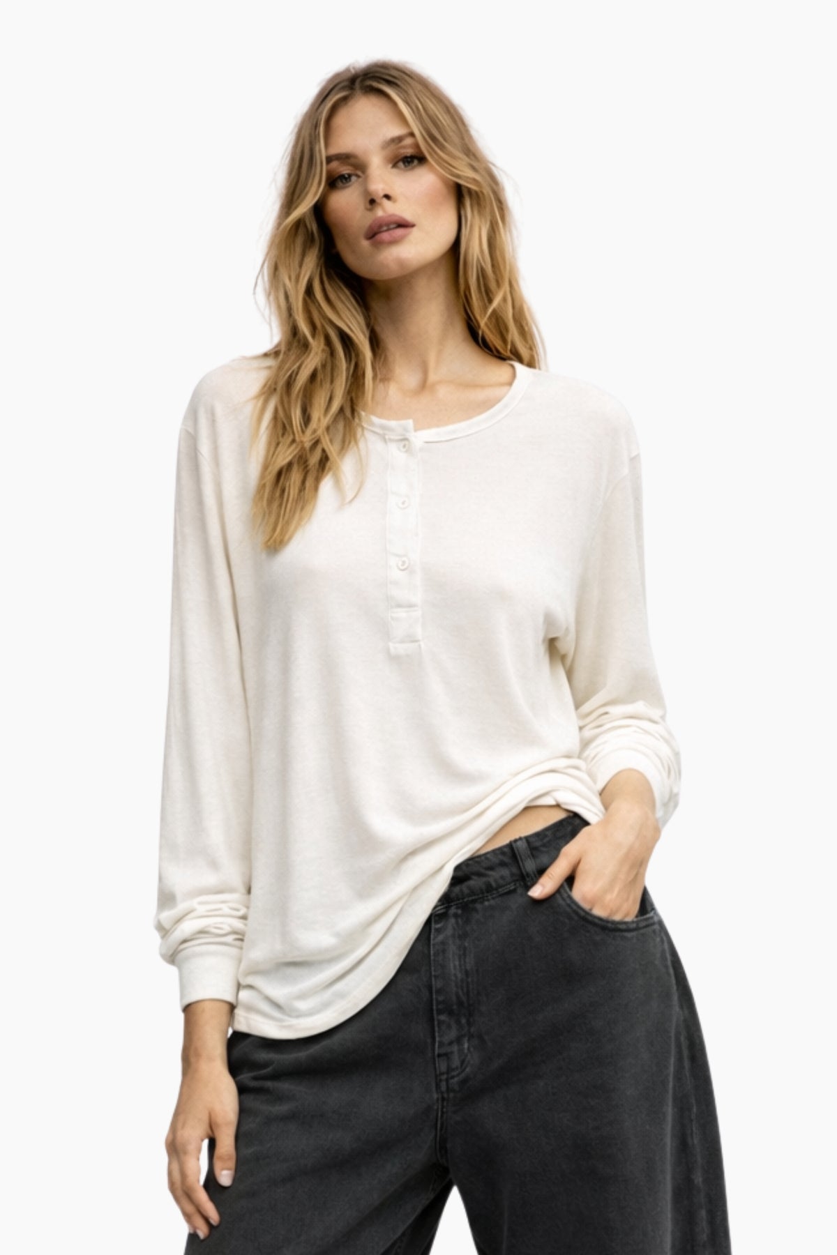 Woman wearing a white blouse and black pants on a white background