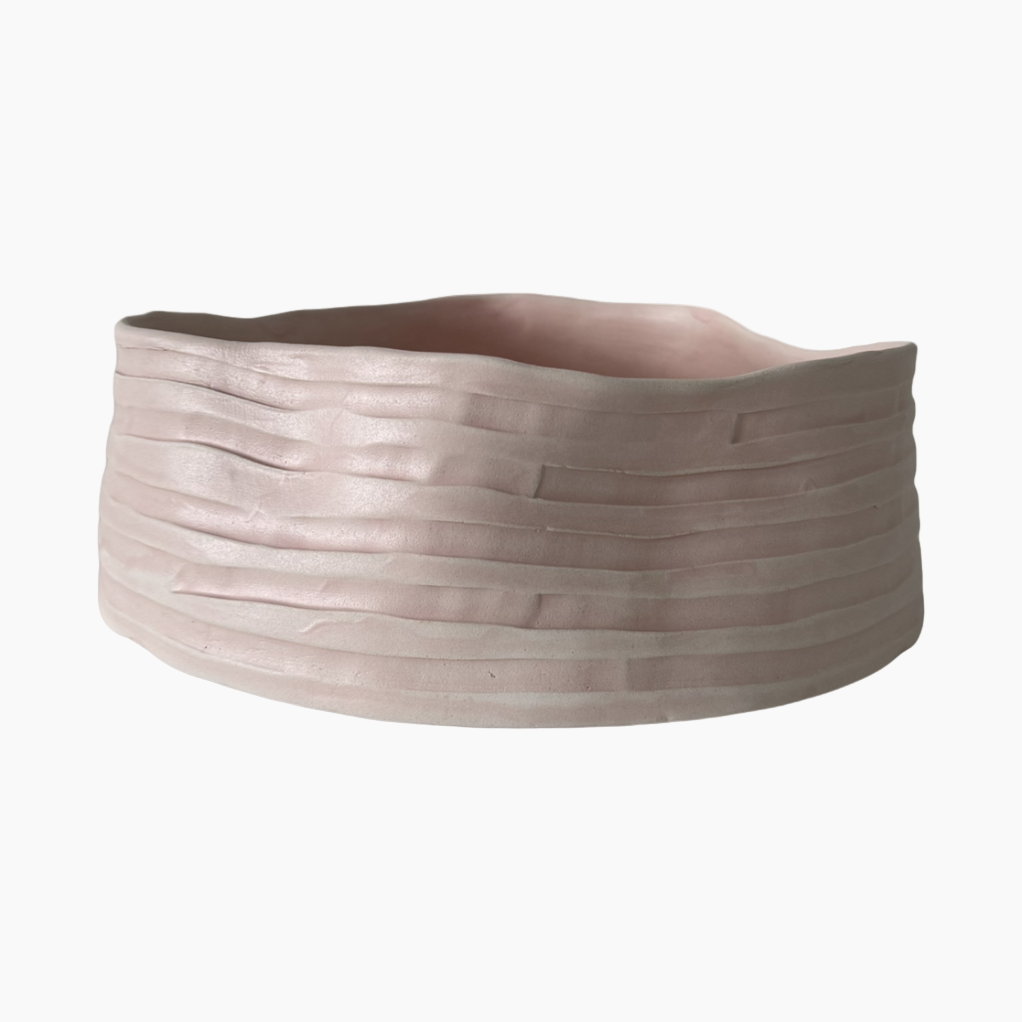 Ceramic planter with textured surface on a white background