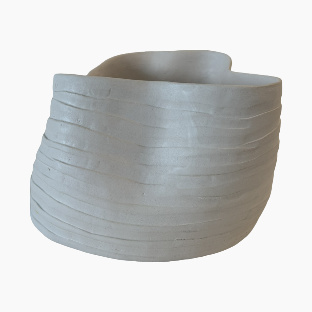 Gray ceramic planter with wavy texture on a white background
