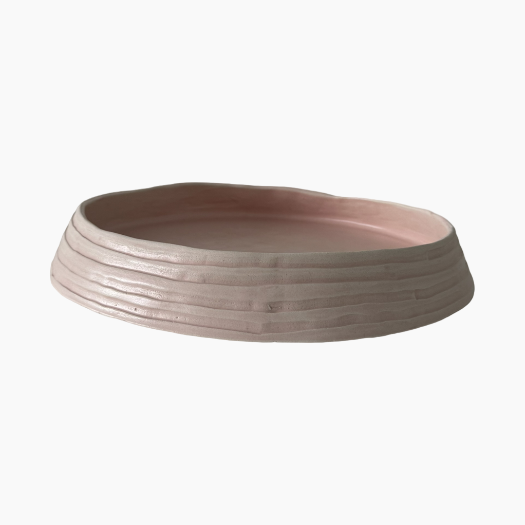 Ceramic bowl with a ribbed texture on a white background
