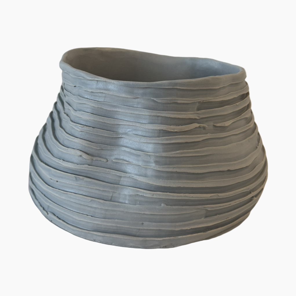 Gray ceramic planter with textured surface on a white background