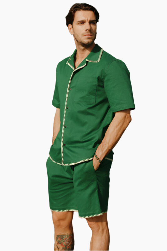 Man wearing a green outfit with white trim.