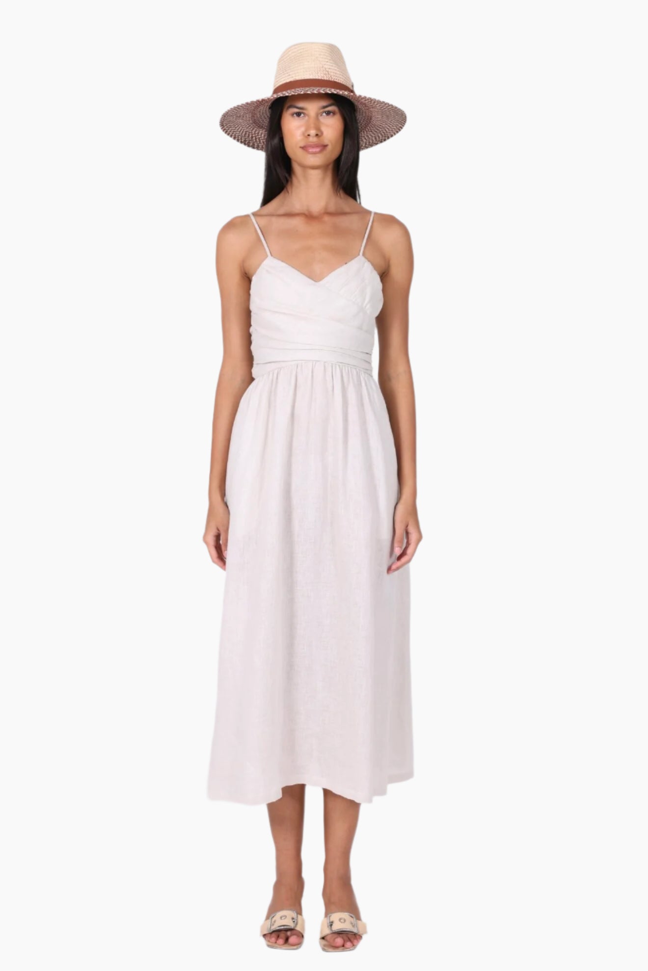 Woman wearing a white dress and straw hat