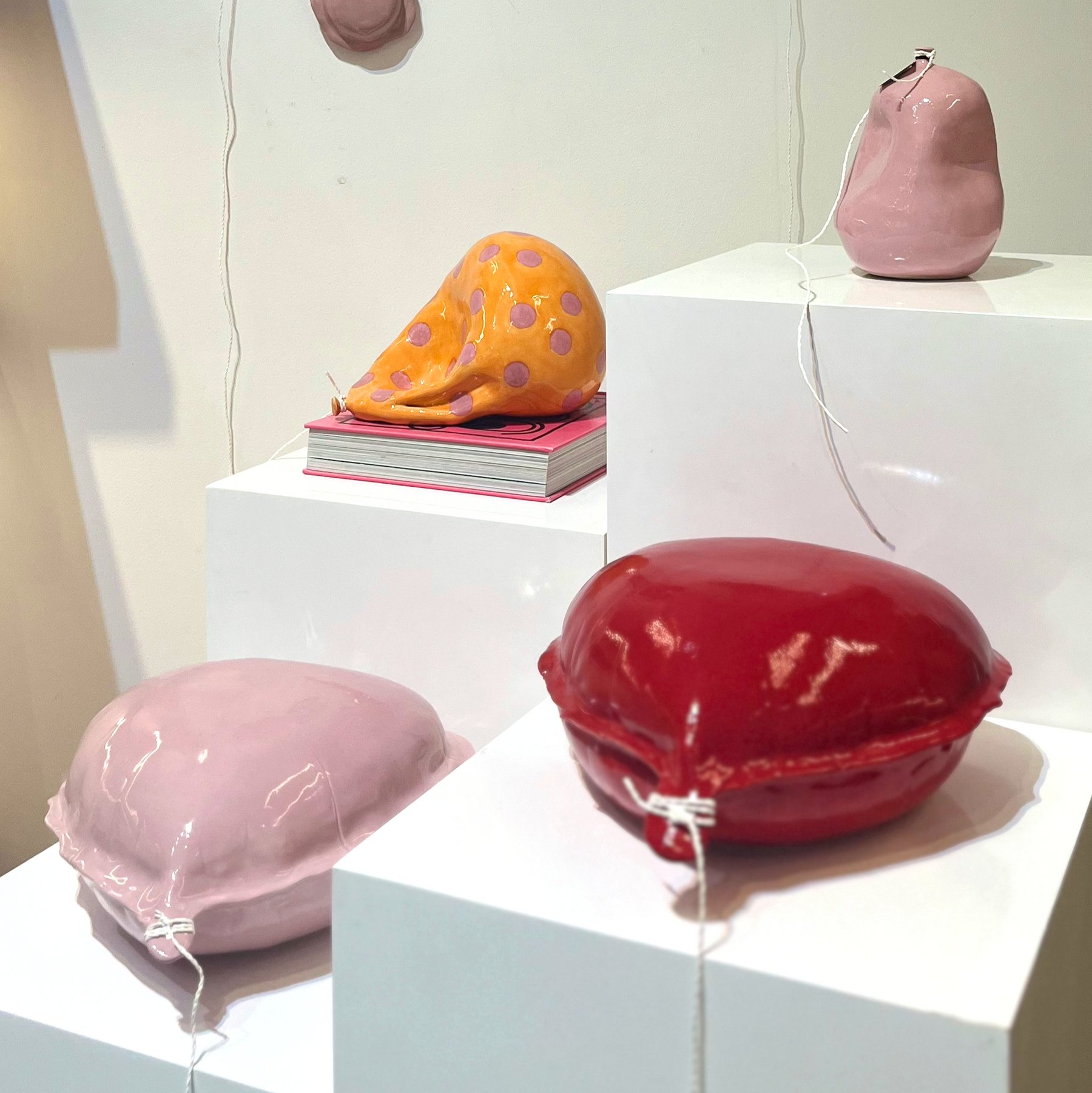 Decorative pink letter balloons and colorful shell-shaped objects .