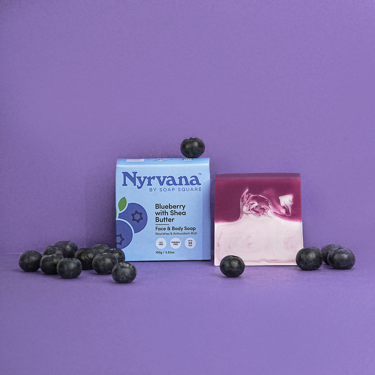 Nyrvana by Soap Squared blueberry soap bar with packaging on a purple background