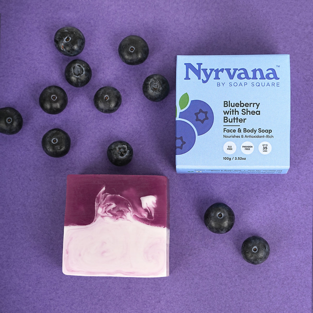 Nyrvana Blueberry with Shea Butter soap and blueberries on a purple background