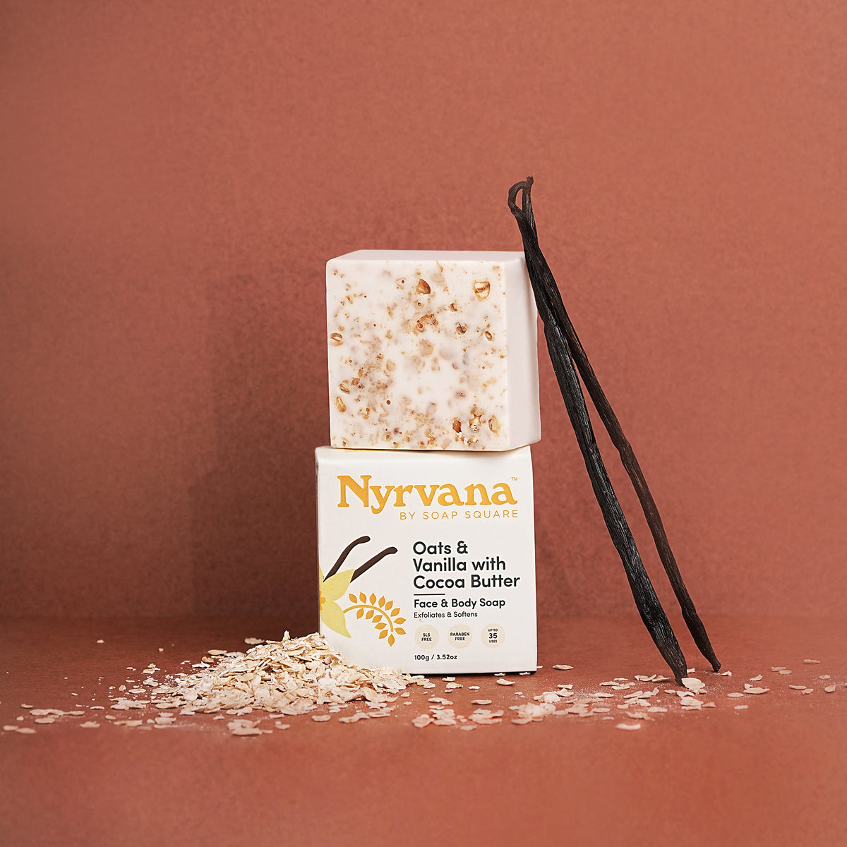 Nyrvana oatmeal vanilla soap with packaging and vanilla beans on a brown background