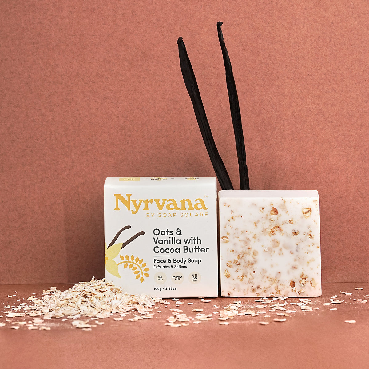 Nyrvana soap bar with packaging and vanilla beans on a pink background