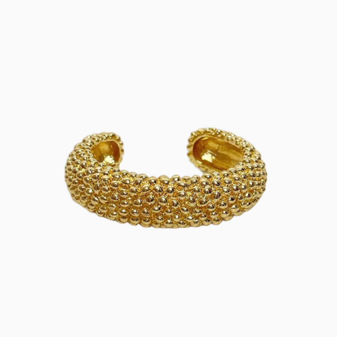 Gold beaded cuff bracelet on a white background